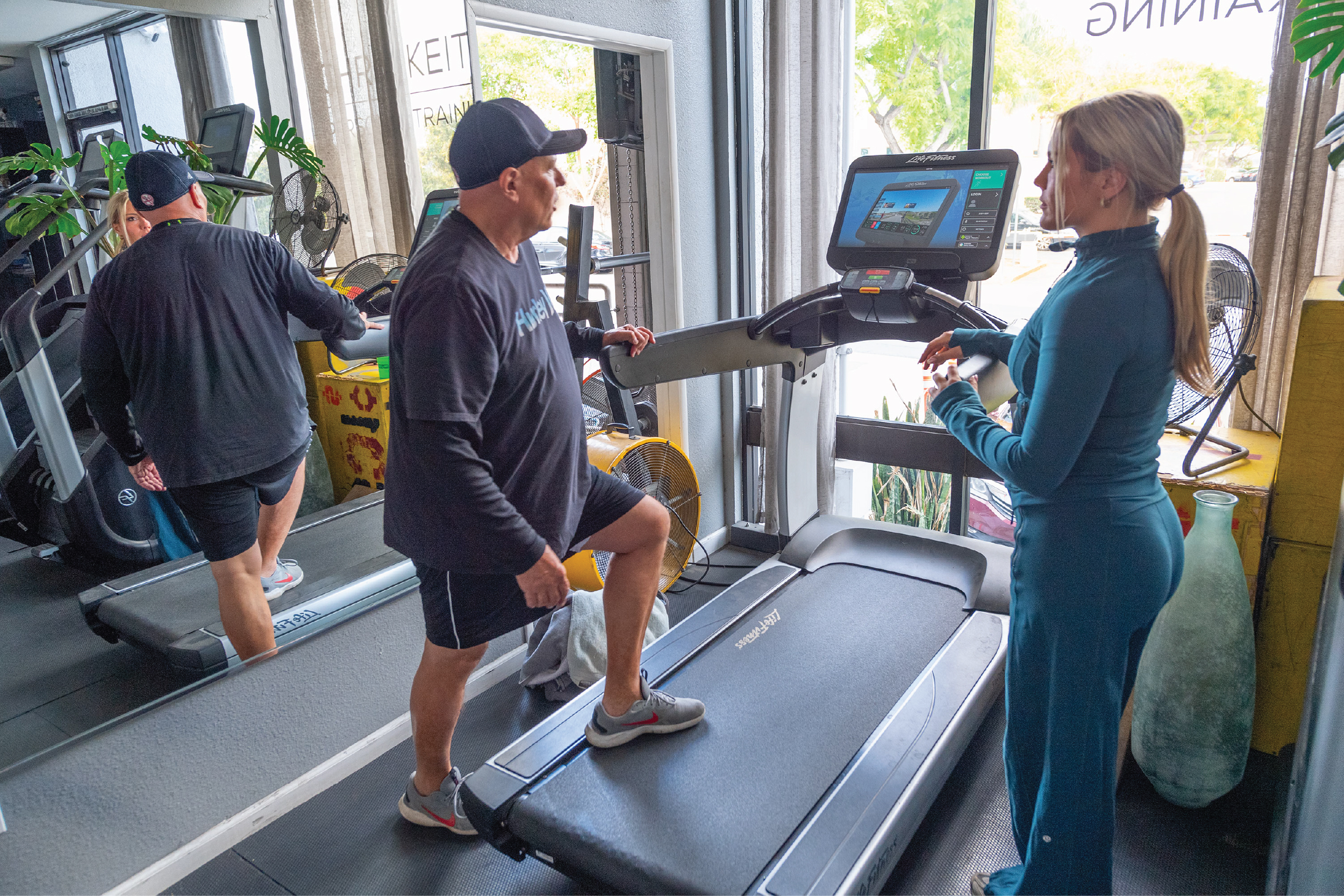 Coach Taylor-SDPT-Website Mockup-Final-2_Coach Taylor-The Program-Gallery 7 Taylor Battista-Coach Taylor-SD Personal Trainer training a client on the treadmill