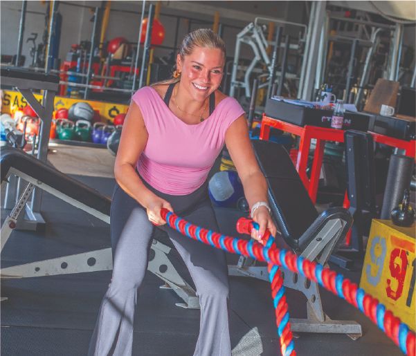 Coach Taylor Battista training with battle ropes in her Hillcrest, San Diego gym